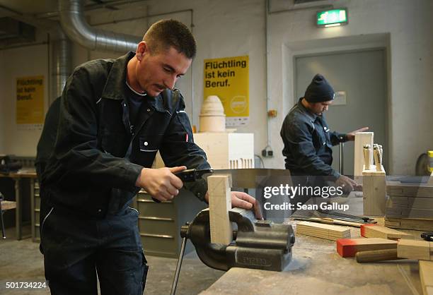 Asylum-applicants from Kosovo participate in the cabinet-making tradecrafts exposure program at the Arrivo center on December 17, 2015 in Berlin,...