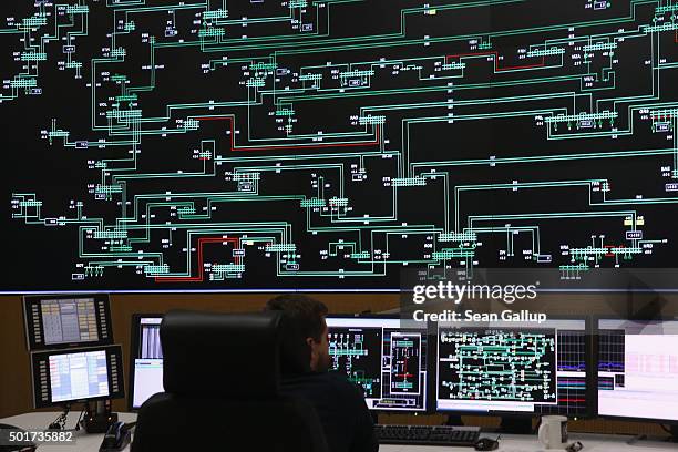 Technician monitors electricity levels in front of a giant screen showing the eastern German electricity transmission grid in the control center of...