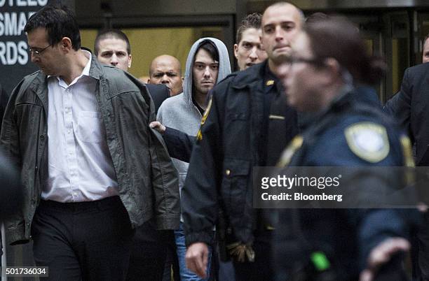 Martin Shkreli, chief executive officer of Turing Pharmaceuticals LLC, center, and attorney Evan Greebel, left, exit federal court in New York, U.S.,...