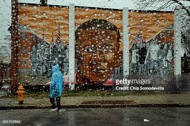 Rain falls on the Sandtown neighborhood where Freddie Gray dipicted in a mural with civil rights leaders, lived and was arrested earlier this year...