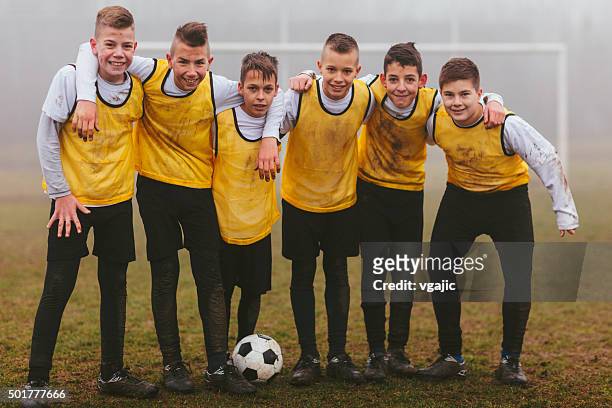 kids team photo after playing soccer. - soccer uniform stockfoto's en -beelden