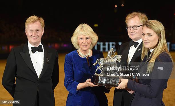 Camilla, Duchess of Cornwall presents the Raymond Brooks-Ward Memorial Trophy to winner Jessica Mendoza during The London International Horse Show at...