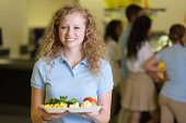Cute high school student looking disgusted by cafeteria food
