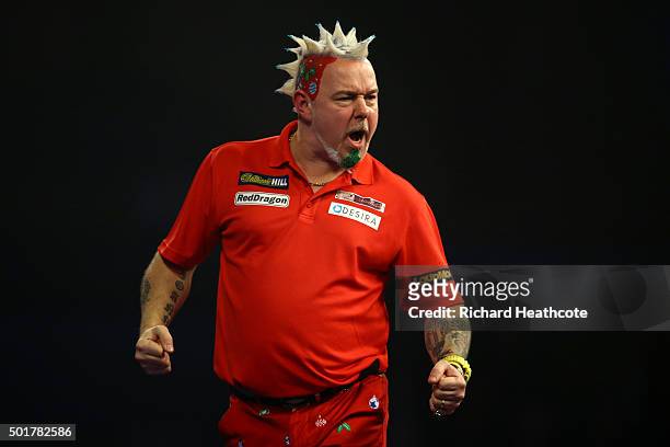 Peter Wright reacts to winning during his first round match against Keegan Brown on day one of the 2016 William Hill PDC World Darts Championships at...