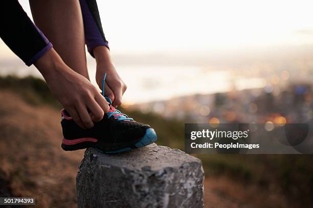 fastening those laces for a fast-paced fun - road running stock pictures, royalty-free photos & images