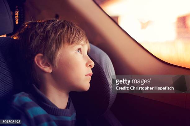 boy in a car at night - kids inside car fotografías e imágenes de stock