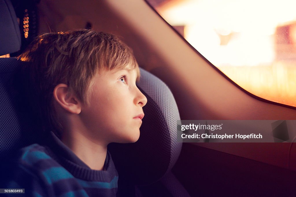Boy in a car at night