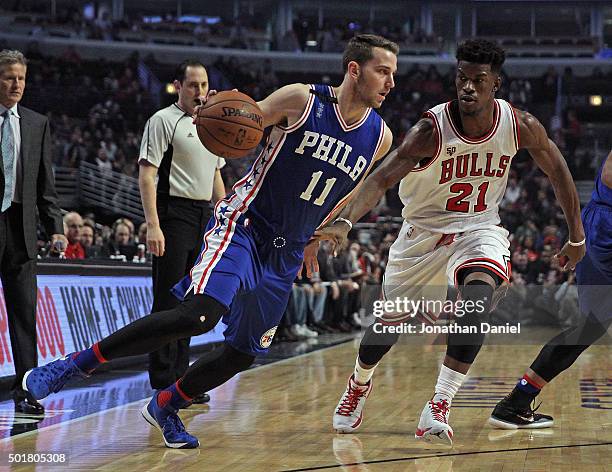 Nik Stauskas of the Philadelphia 76ers dirves against Jimmy Butler of the Chicago Bulls at the United Center on December 14, 2015 in Chicago,...