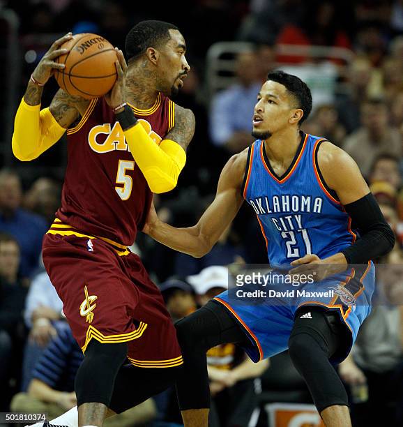 Andre Roberson of the Oklahoma City Thunder defends against J.R. Smith of the Cleveland Cavaliers during the first half of their game on December 17,...
