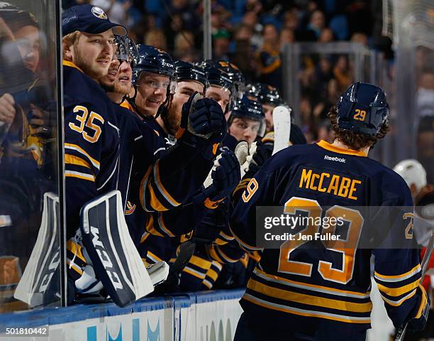 Jake McCabe of the Buffalo Sabres celebrates his goal against the Anaheim Ducks with teammates along the bench, including Linus Ullmark, at First...