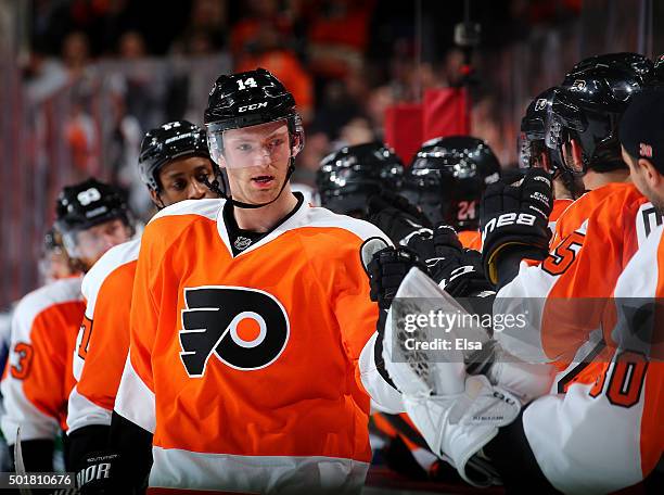 Sean Couturier of the Philadelphia Flyers celebrates his goal with teammates on the bench in the third period against the Vancouver Canucks on...