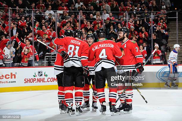 Teuvo Teravainen of the Chicago Blackhawks and Brent Seabrook celebrate with teammates after Teravainen scored against the Edmonton Oilers in the...
