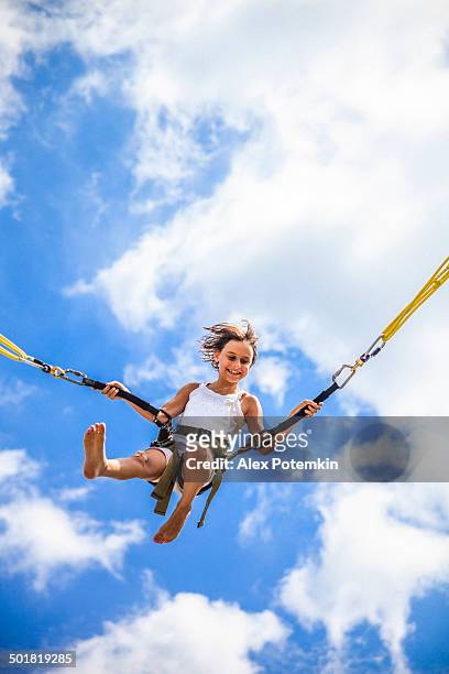 little girl bungee jumping at trampoline - bungee jump stockfoto's en -beelden