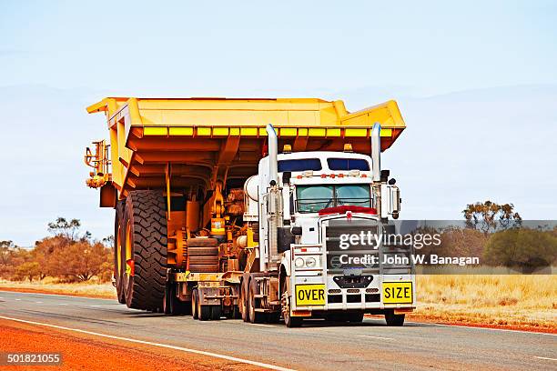 dump truck being transported, w.a. - banagan dumper truck stock pictures, royalty-free photos & images
