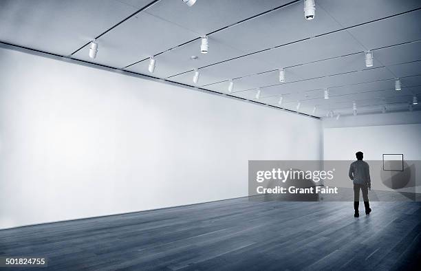 man in empty room - gallery wall stock pictures, royalty-free photos & images