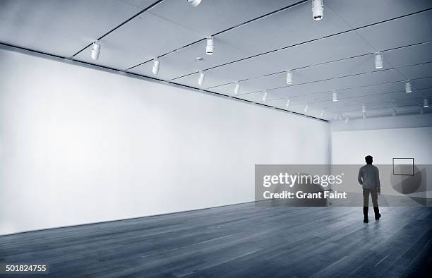 man in empty room - gallery space imagens e fotografias de stock
