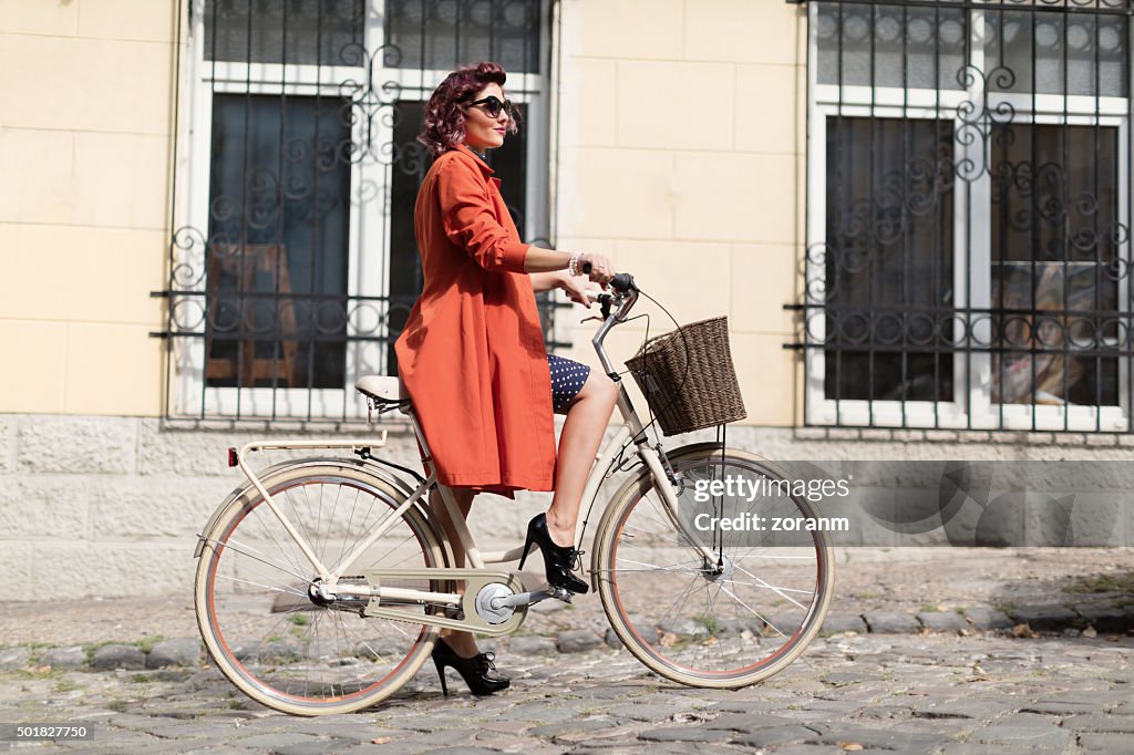 Retro styled woman riding a bike