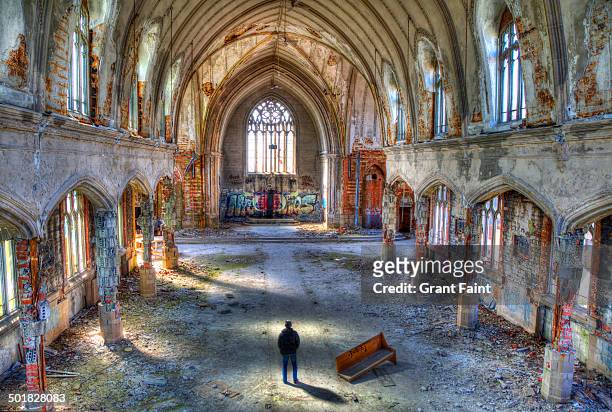 man standing in abandoned church - detroit michigan stock pictures, royalty-free photos & images