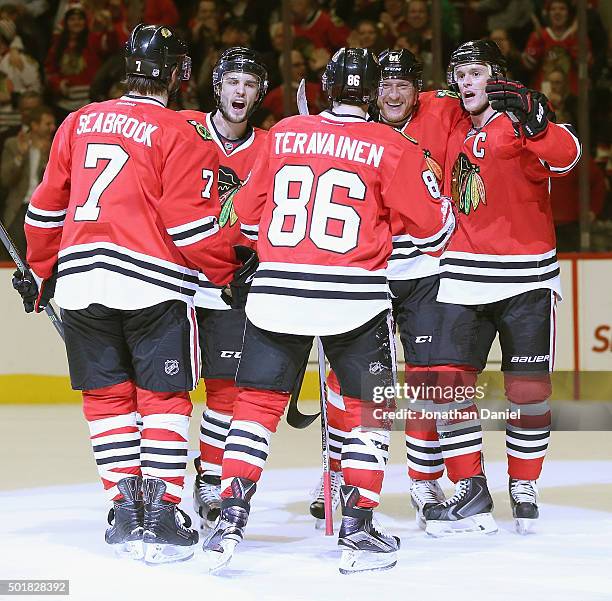 Brent Seabrook, Niklas Hjalmarsson, Marian Hossa and Jonathan Toews of the Chicago Blackhawks move to congratulate teammate Teuvo Teravainen after...