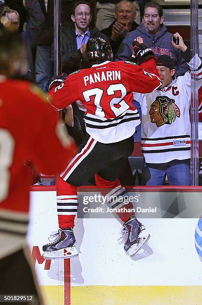 Artemi Panarin of the Chicago Blackhawks jumps off the glass to celebrate his third period goal against the Edmonton Oilers at the United Center on...