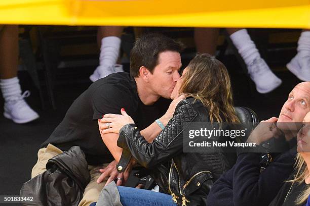Mark Wahlberg and Rhea Durham kiss at a basketball game between the Houston Rockets and the Los Angeles Lakers at Staples Center on December 17, 2015...