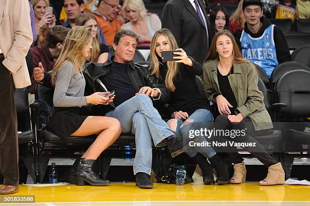 Sistine Rose Stallone, Sylvester Stallone, Sophia Rose Stallone and Scarlet Rose Stallone attend a basketball game between the Houston Rockets and...