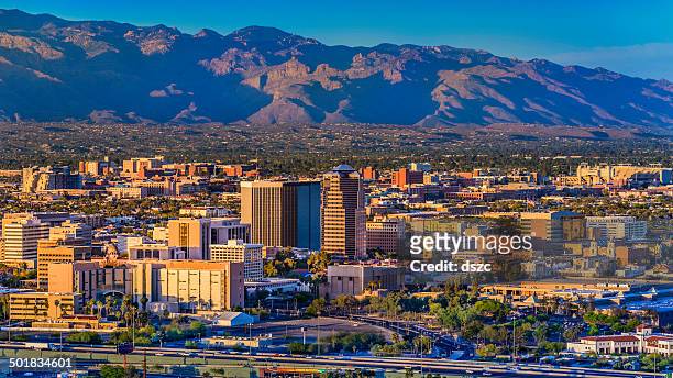 tucson arizona skyline cityscape and santa catalina mountains at sunset - helicopter point of view stock pictures, royalty-free photos & images