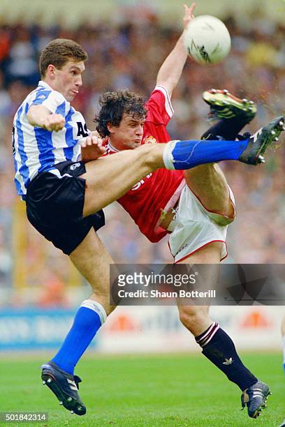 Sheffield Wednesday captain Nigel Pearson challenges Mark Hughes of Manchester United during the 1991 League Cup Final between Sheffield Wednesday...