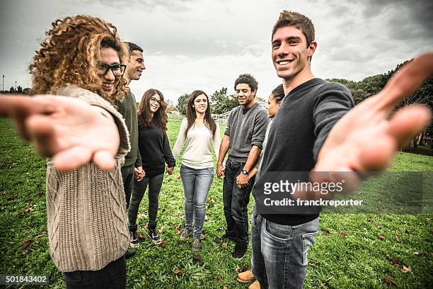 friends embraced enjoy holding hands - hold hands circle stock pictures, royalty-free photos & images