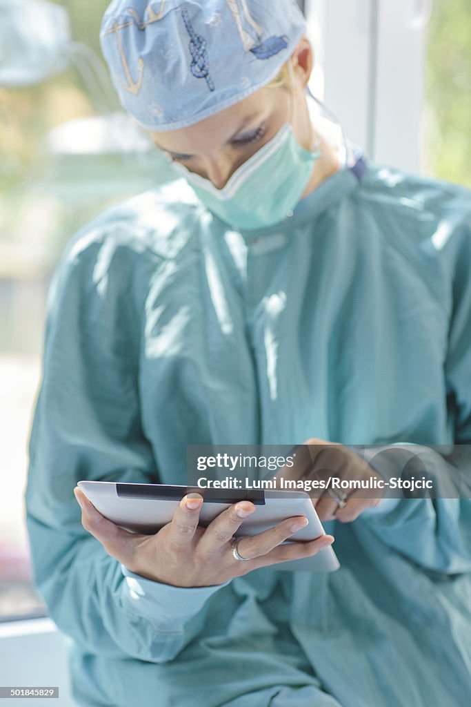 Female Surgeon Using Tablet PC