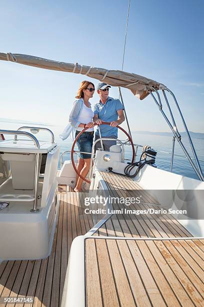 mature couple sailing together, adriatic sea, croatia - yachting lifestyle stock pictures, royalty-free photos & images