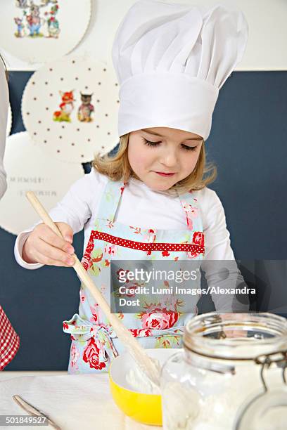 little girl with chef's hat preparing dough, munich, bavaria, germany - alexandra dost stock-fotos und bilder