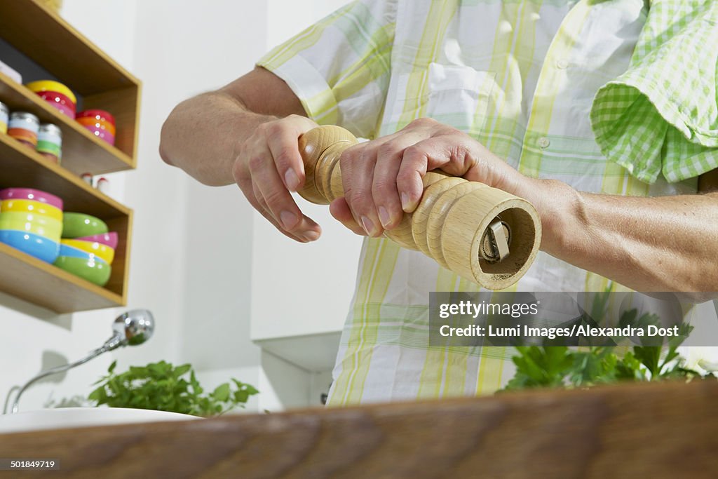 Man Holding Pepper Mill In Hands