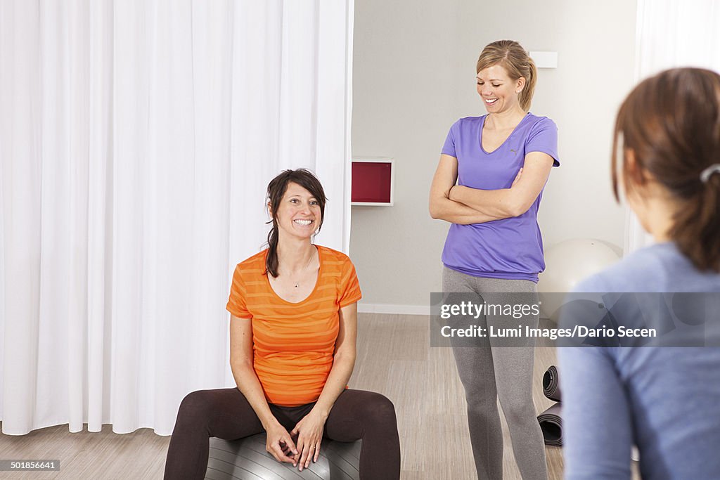 Three women taking a break in gym