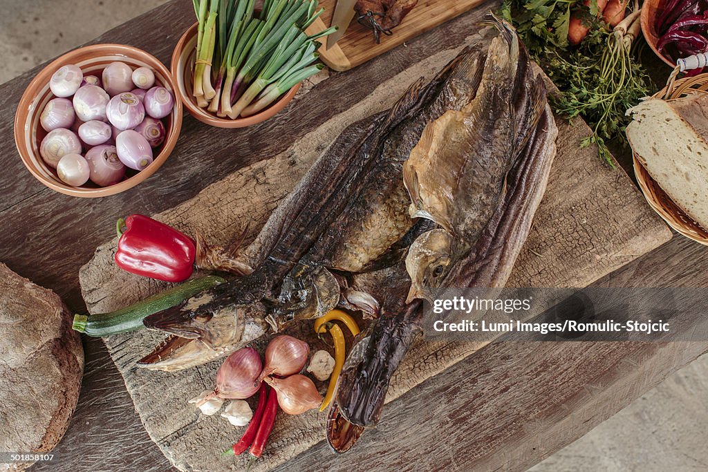 Pike fish among variety of ingredients and vegetables