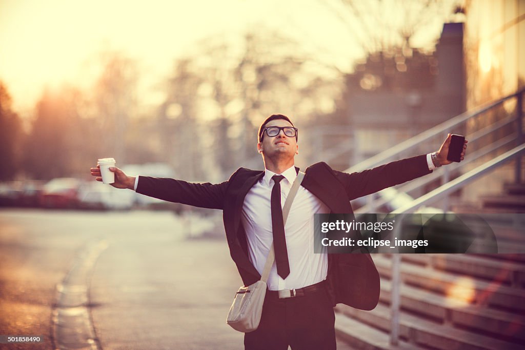 Businessman smiling with arms outstretched