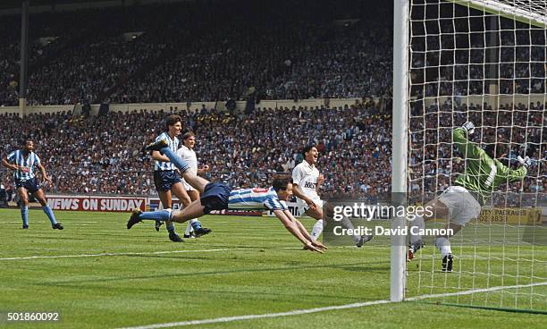 Coventry striker Keith Houchen dives to head the second goal past Spurs goalkeeper Ray Clemence as defender Chris Houghton reacts during the 1987 FA...