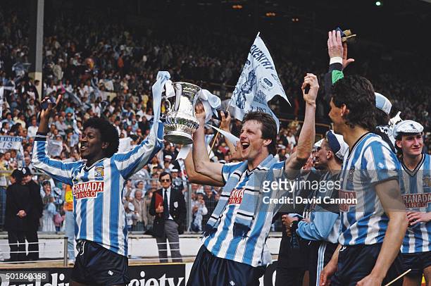 Coventry goalscorers Dave Bennett and Keith Houchen hold the trophy aloft after the 1987 FA Cup Final between Coventry City and Tottenham Hotspur at...
