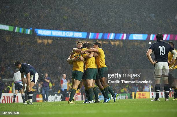 World Cup: Australia players victorious after scoring try during Quarterfinals - Match 44 vs Scotland at Twickenham Stadium. Rain, weather. London,...