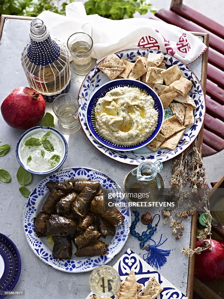 Still life of yogurt eggplant dips and dolmade