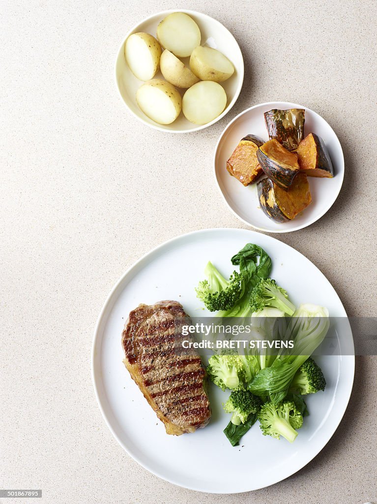 Still life of grilled steak with healthy vegetable sides