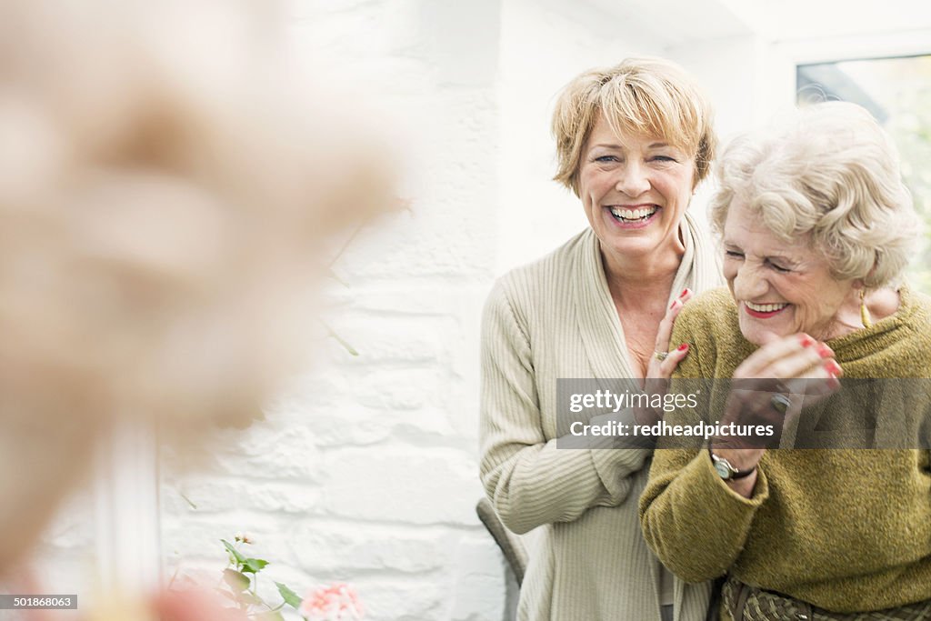 Senior woman with daughter, laughing