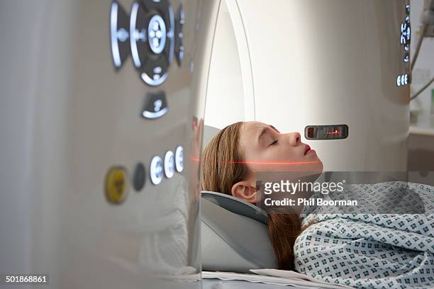 girl going into ct scanner - medical scanner fotografías e imágenes de stock