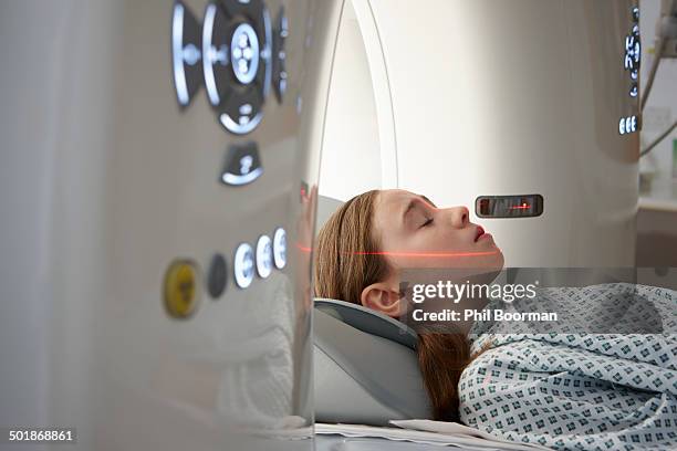 girl going into ct scanner - cat scan machine stock pictures, royalty-free photos & images