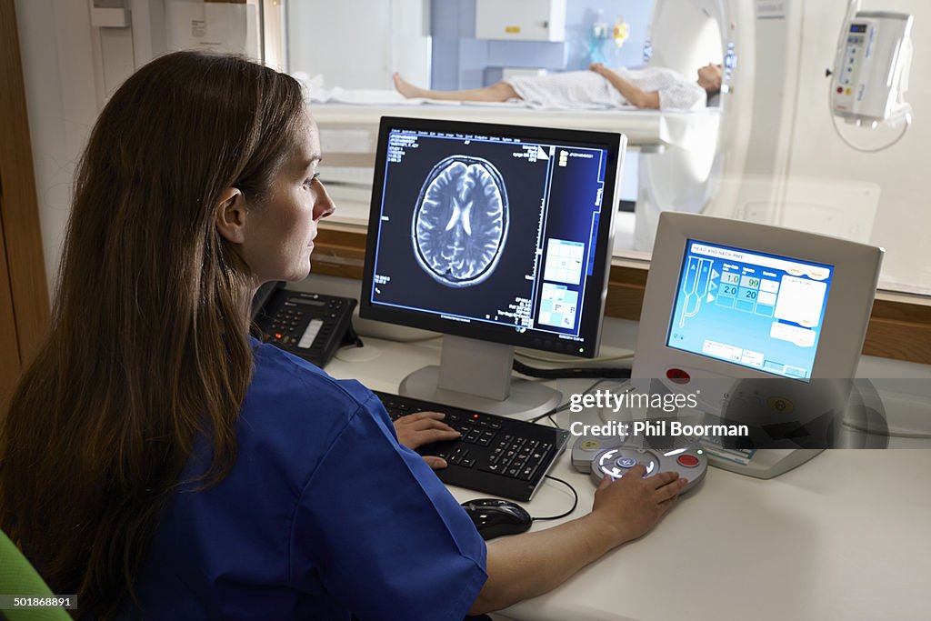 Radiologist looking at brain scan image on computer screen