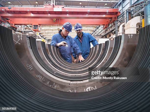 engineers inspecting turbine housing during power station outage - extra portraits stockfoto's en -beelden