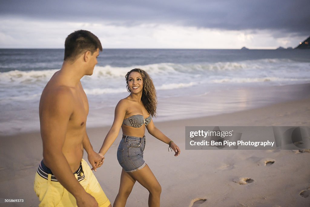 Romantic young couple strolling on Ipanema Beach, Rio de Janeiro, Brazil