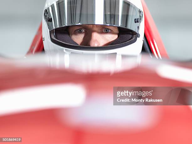 close up portrait of racing car driver wearing helmet in supercar - pilota di auto da corsa foto e immagini stock