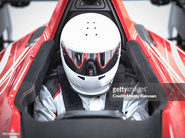 racing driver wearing crash helmet in supercar - race driver stock-fotos und bilder
