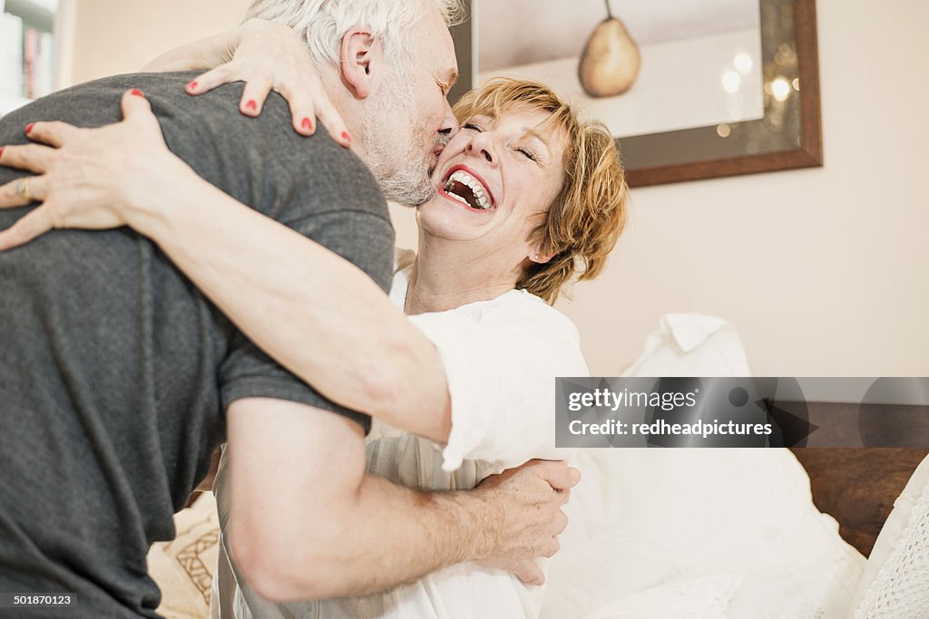 Couple hugging, mature woman laughing